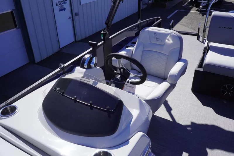 Slide: The Image of 2025 Lowe SS 230 DL boat interior with steering wheel and seating. - 49