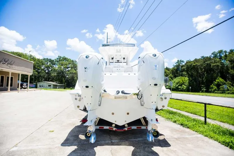 Slide: The Image of 2021 Sea Fox 368 Commander boat with dual outboard engines, parked outdoors. - 1
