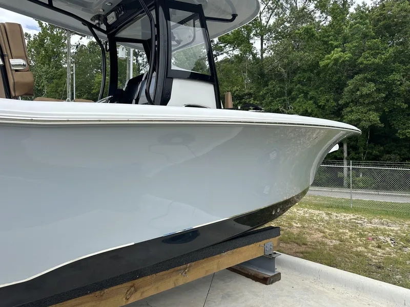 Slide: The Image of 2020 Sea Hunt Gamefish 30 boat with coffin box, displayed outdoors. - 2