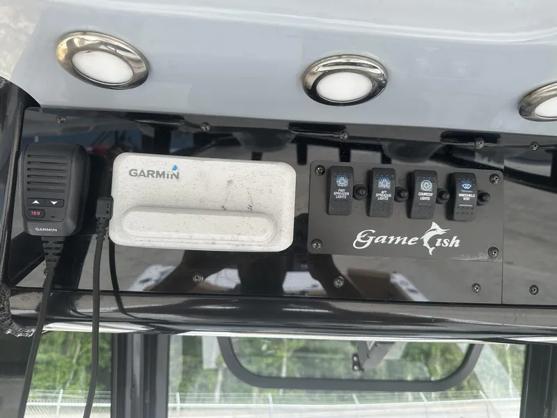 Slide: The Image of Control panel of a 2020 Sea Hunt Gamefish 30 boat with Garmin device and light switches. - 22