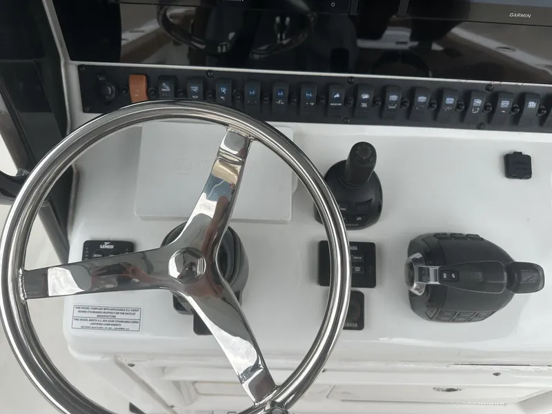Slide: The Image of 2020 Sea Hunt Gamefish 30 helm with steering wheel and controls. - 24