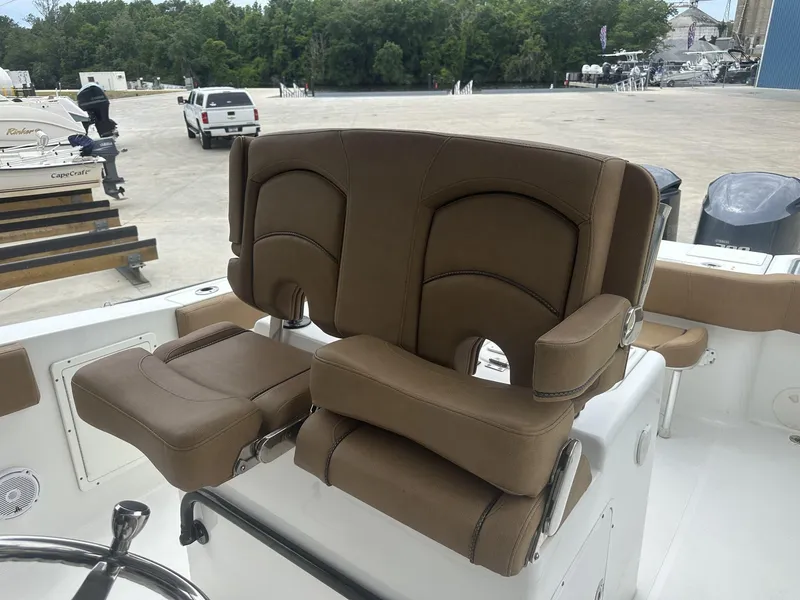 Slide: The Image of 2020 Sea Hunt Gamefish 30 boat seat with brown upholstery and armrests. - 26