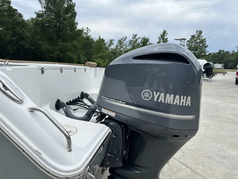Slide: The Image of 2020 Sea Hunt Gamefish 30 with Yamaha outboard motor, parked outdoors. - 6