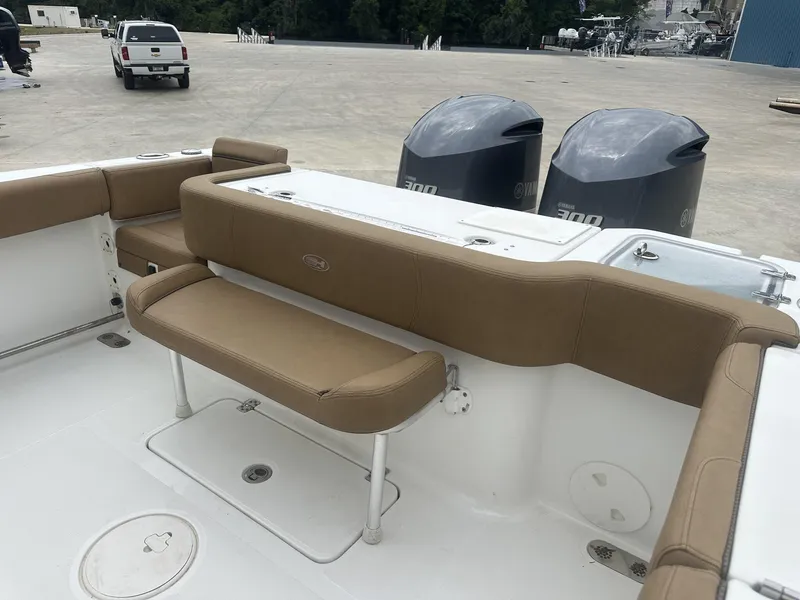Slide: The Image of 2020 Sea Hunt Gamefish 30 boat interior with brown seating and twin Yamaha engines. - 15