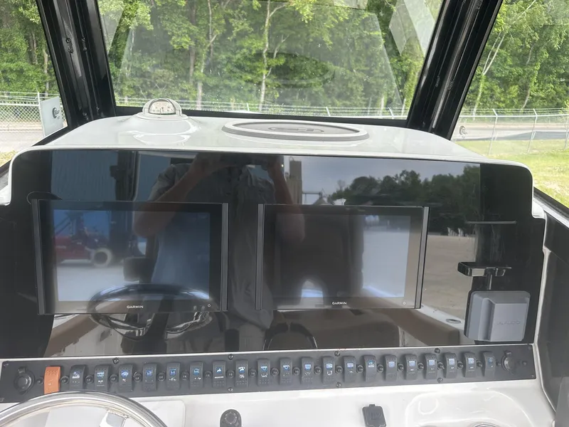 Slide: The Image of 2020 Sea Hunt Gamefish 30 dashboard with dual Garmin displays and control panel. - 25