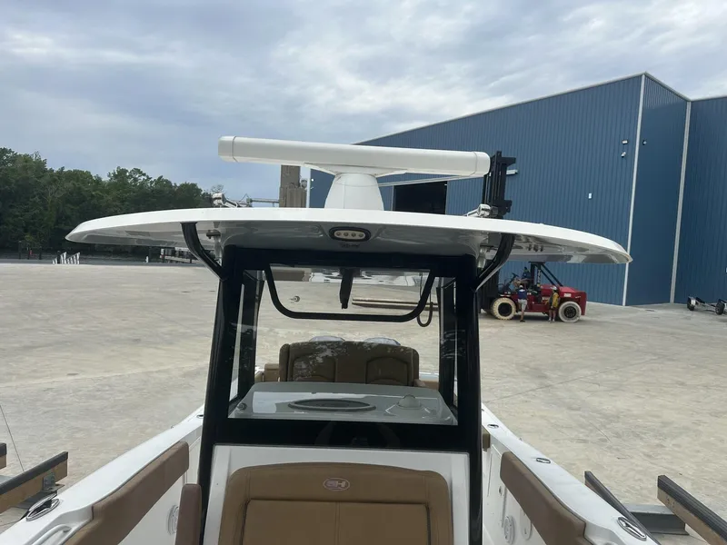 Slide: The Image of 2020 Sea Hunt Gamefish 30 with Coffin Box, docked near a blue warehouse. - 35