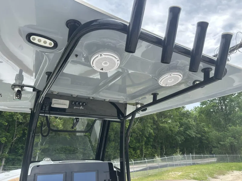 Slide: The Image of 2020 Sea Hunt Gamefish 30 boat console with rod holders and speakers. - 37