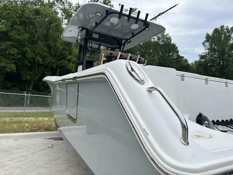 Slide: The Image of 2020 Sea Hunt Gamefish 30 with Coffin Box, sleek design, parked outdoors. - 7