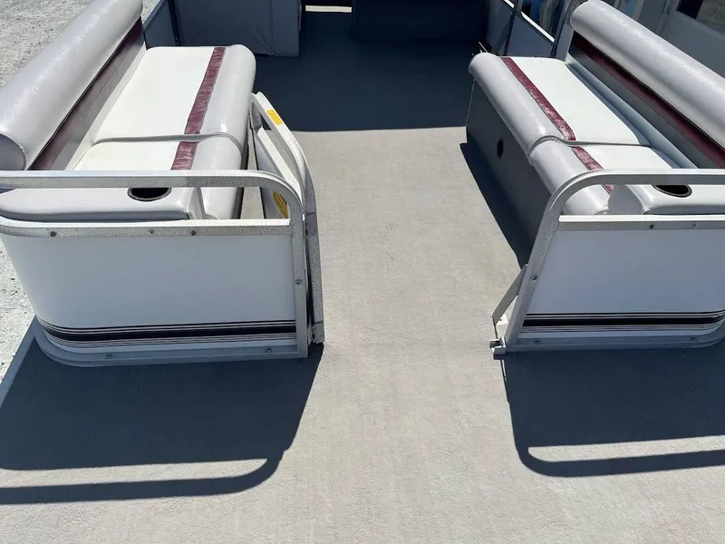 Slide: The Image of 1991 Godfrey Marine 24 Executive boat interior with cushioned seating and cup holders. - 3