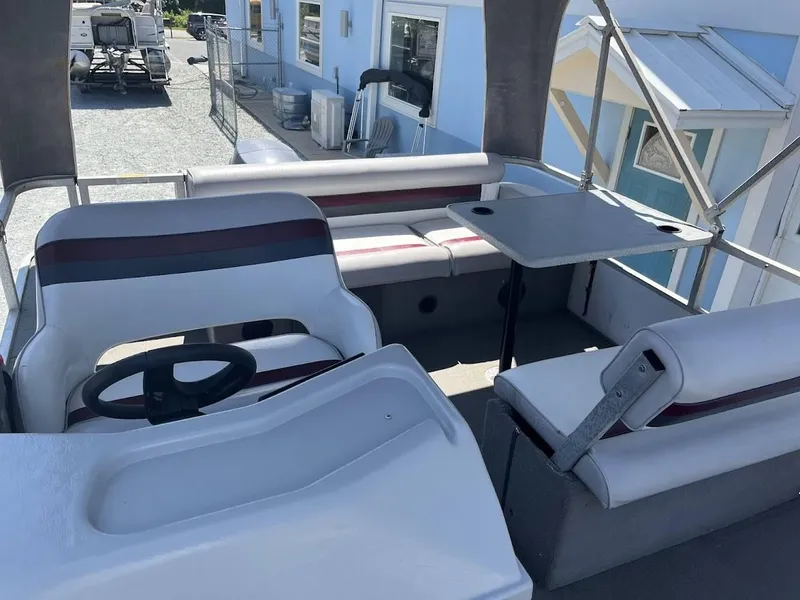 Slide: The Image of 1991 Godfrey Marine 24 Executive boat interior with seating and table. - 5