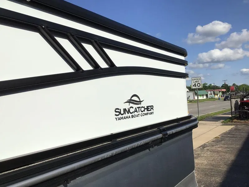 Slide: The Image of 2025 G3 Select 322RF Suncatcher boat by Yamaha, parked near a road with speed limit sign. - 16