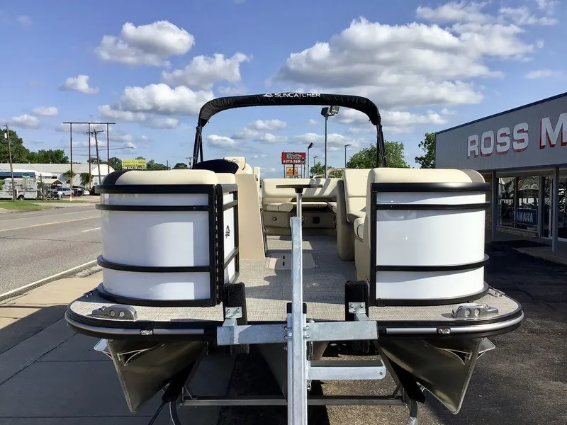 Slide: The Image of 2025 G3 Select 322RF pontoon boat on trailer, parked near dealership under blue sky. - 17