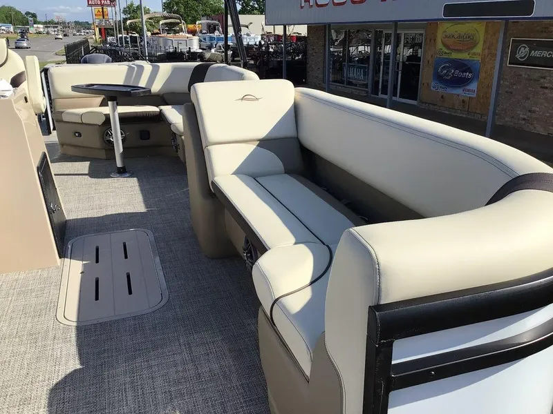 Slide: The Image of 2025 G3 Select 322RF pontoon boat interior with beige seating and table. - 21