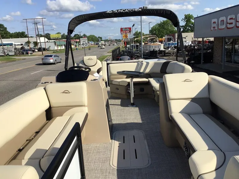 Slide: The Image of 2025 G3 Select 322RF pontoon boat with beige seating, parked on a street. - 22