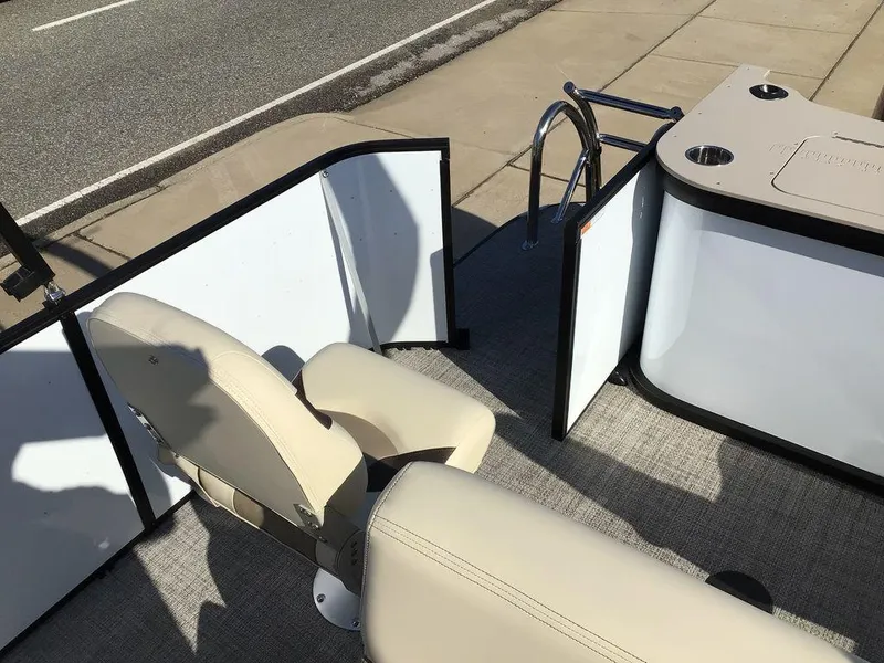 Slide: The Image of 2025 G3 Select 322RF boat interior with beige seating and open gate. - 25