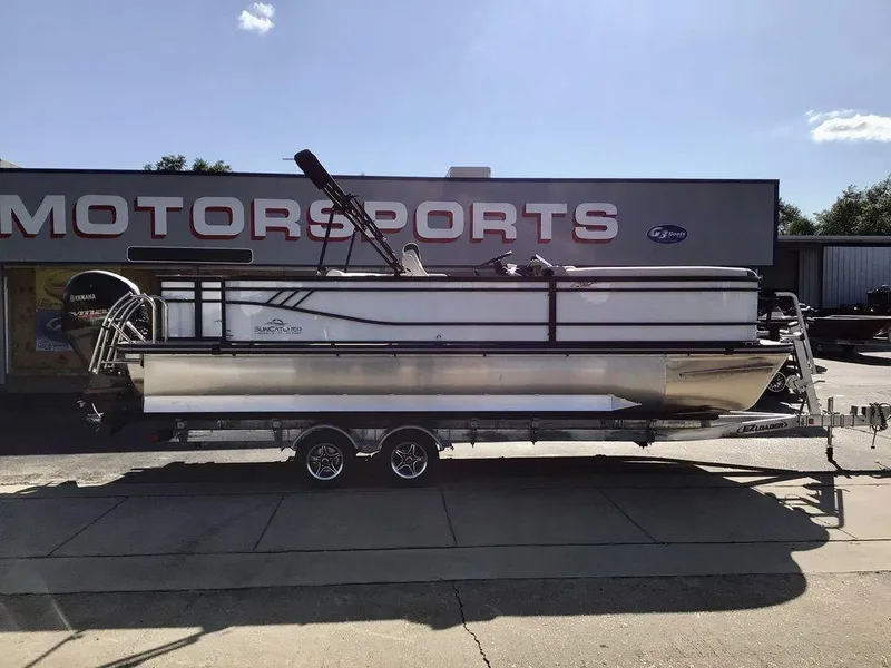 Slide: The Image of 2025 G3 Select 322RF pontoon boat on trailer outside motorsports store. - 3
