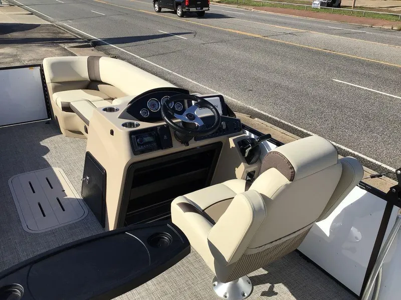 Slide: The Image of 2025 G3 Select 322RF boat interior with steering console and seating on a trailer. - 30