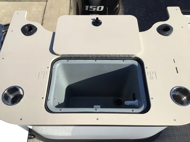 Slide: The Image of 2025 G3 Select 322RF boat with open storage compartment and cup holders. - 32