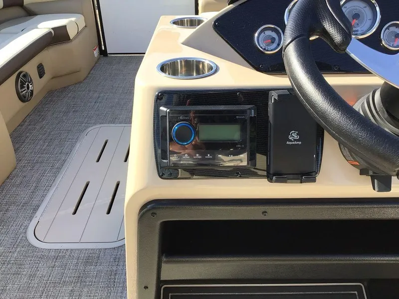 Slide: The Image of 2025 G3 Select 322RF boat dashboard with steering wheel and audio controls. - 34
