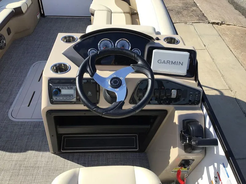 Slide: The Image of 2025 G3 Select 322RF boat dashboard with Garmin navigation system and steering wheel. - 35