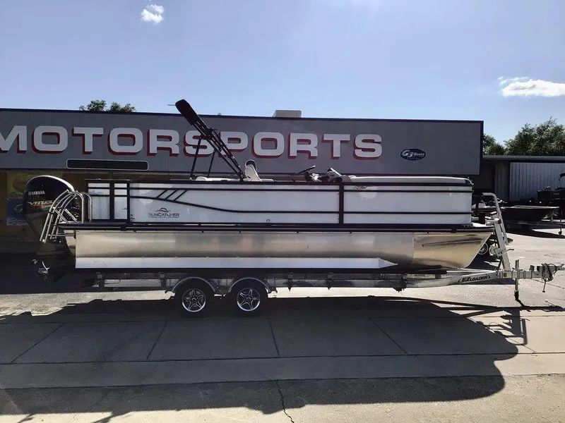 Slide: The Image of 2025 G3 Select 322RF pontoon boat on trailer outside motorsports store. - 4