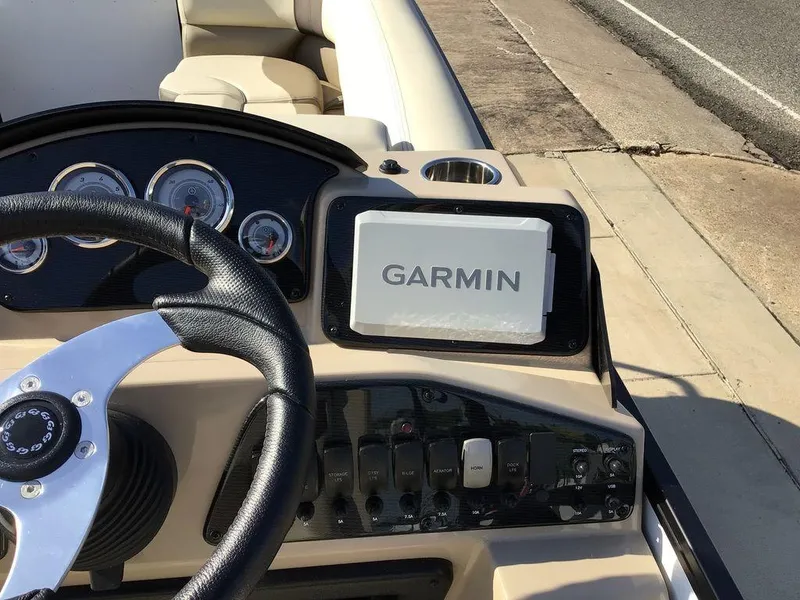 Slide: The Image of Steering wheel and dashboard of 2025 G3 Select 322RF boat with Garmin device. - 42