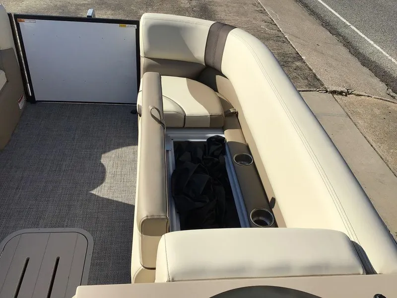 Slide: The Image of 2025 G3 Select 322RF boat interior with beige seating and cup holders. - 43