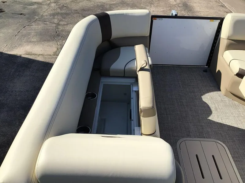 Slide: The Image of 2025 G3 Select 322RF boat interior with beige seating and storage compartment. - 44