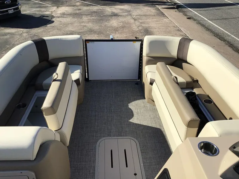 Slide: The Image of 2025 G3 Select 322RF pontoon boat interior with beige seating and cup holders. - 45