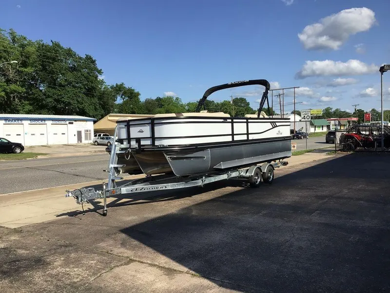 Slide: The Image of 2025 G3 Select 322RF pontoon boat on trailer, parked in urban setting under blue sky. - 48