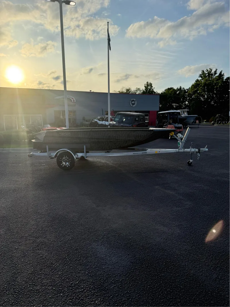 Slide: The Image of 2025 EDGE BOATS 656 DB SPORTSMAN on trailer at sunset in parking lot. - 1