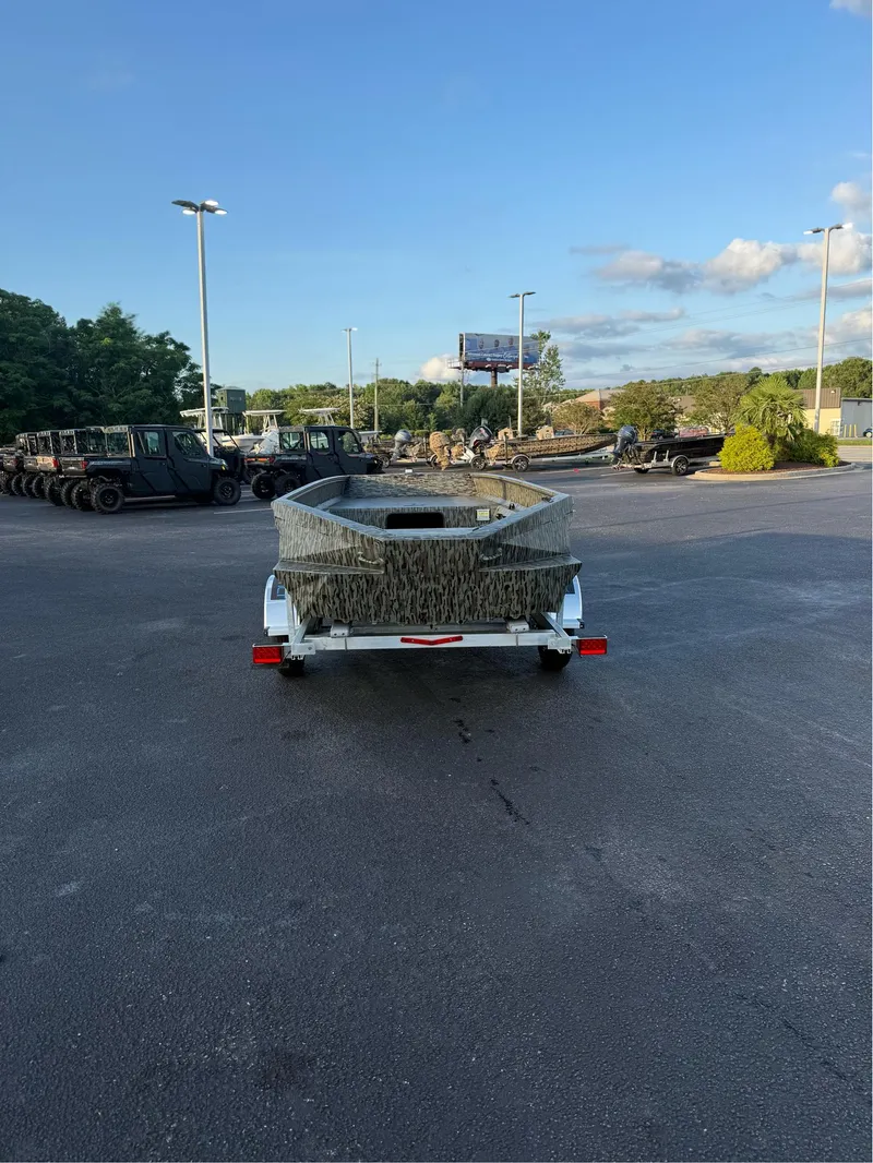 Slide: The Image of 2025 EDGE BOATS 656 DB SPORTSMAN on trailer in parking lot, clear sky background. - 2