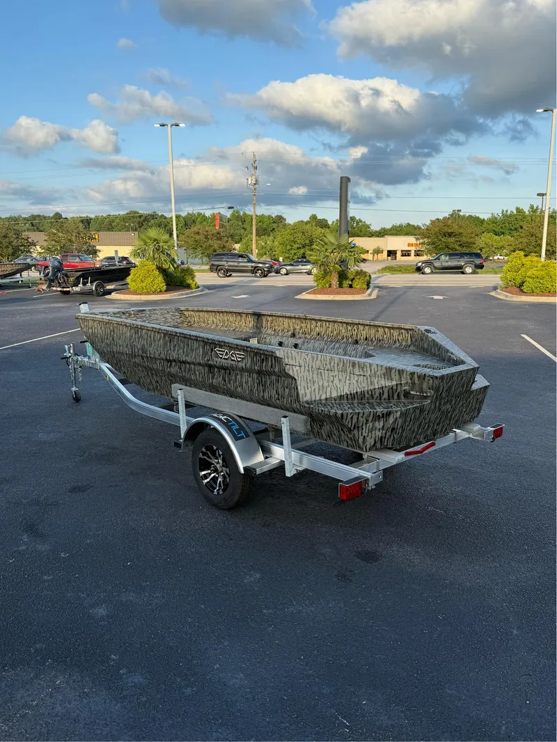 Slide: The Image of 2025 EDGE BOATS 656 DB SPORTSMAN on trailer in parking lot under blue sky. - 4
