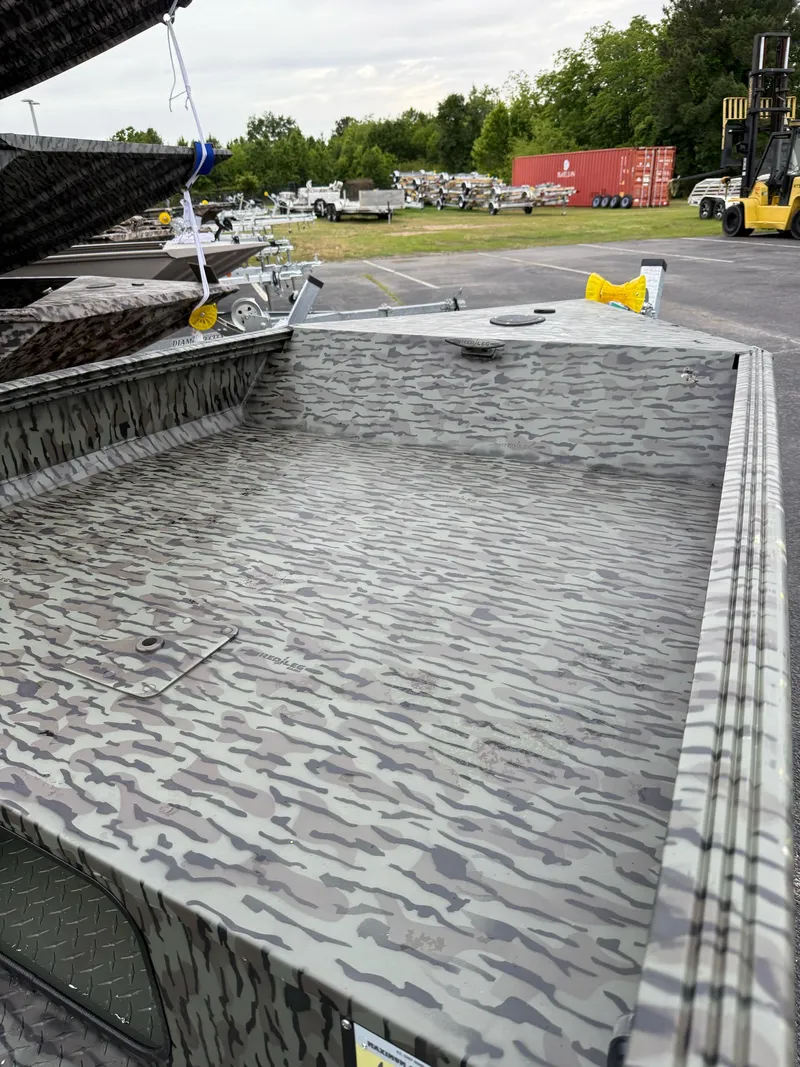 Slide: The Image of 2025 EDGE BOATS 553 Sportsman with camouflage design, parked outdoors. - 4