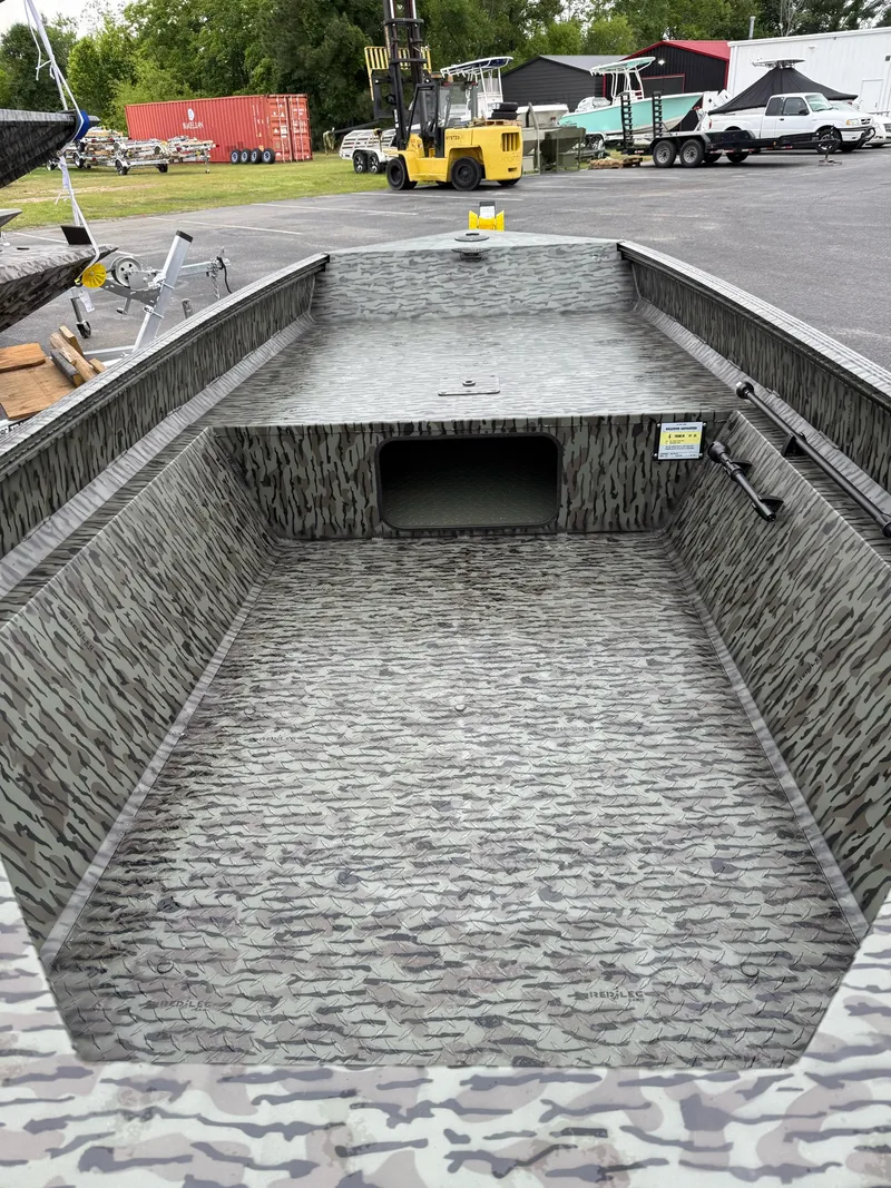 Slide: The Image of 2025 EDGE BOATS 553 Sportsman with camouflage interior, parked outdoors. - 5