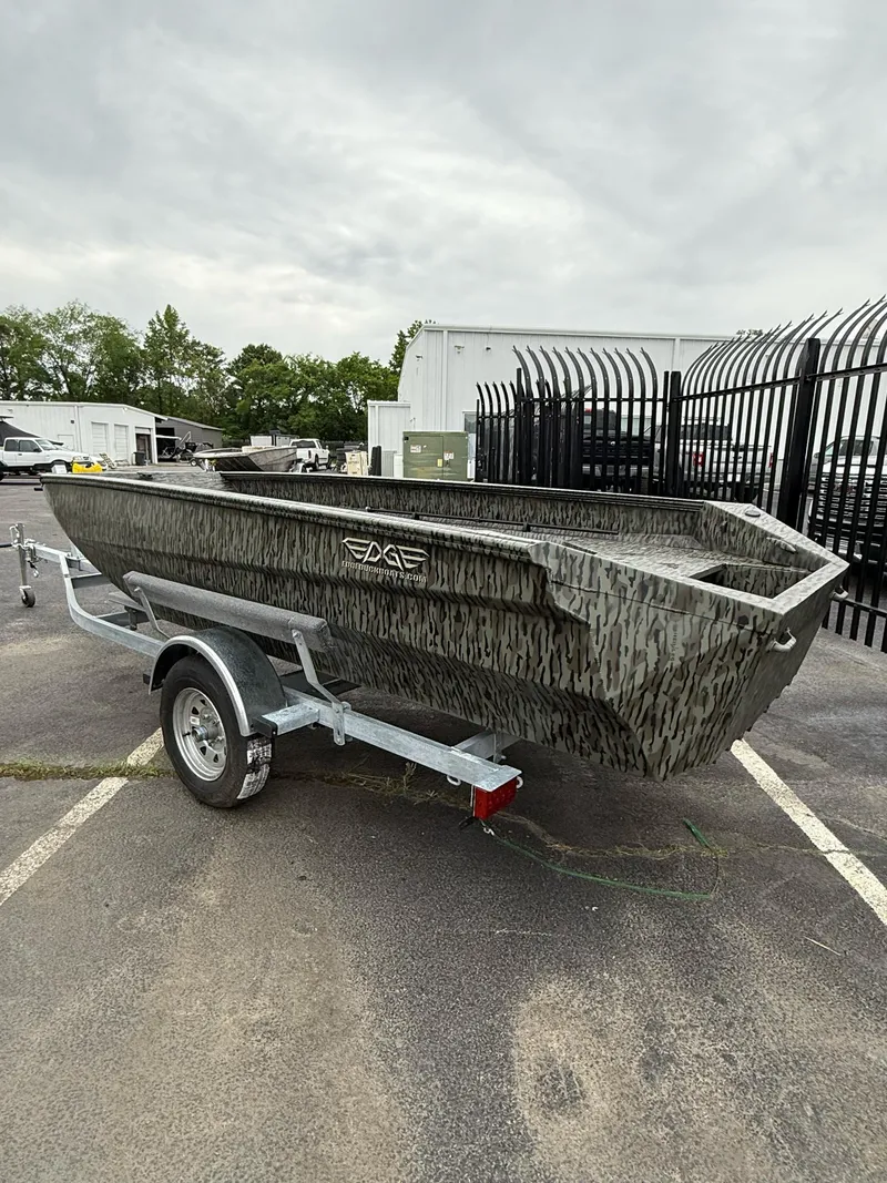 Slide: The Image of 2025 EDGE BOATS 553 Sportsman on trailer, camo design, parked outdoors. - 7