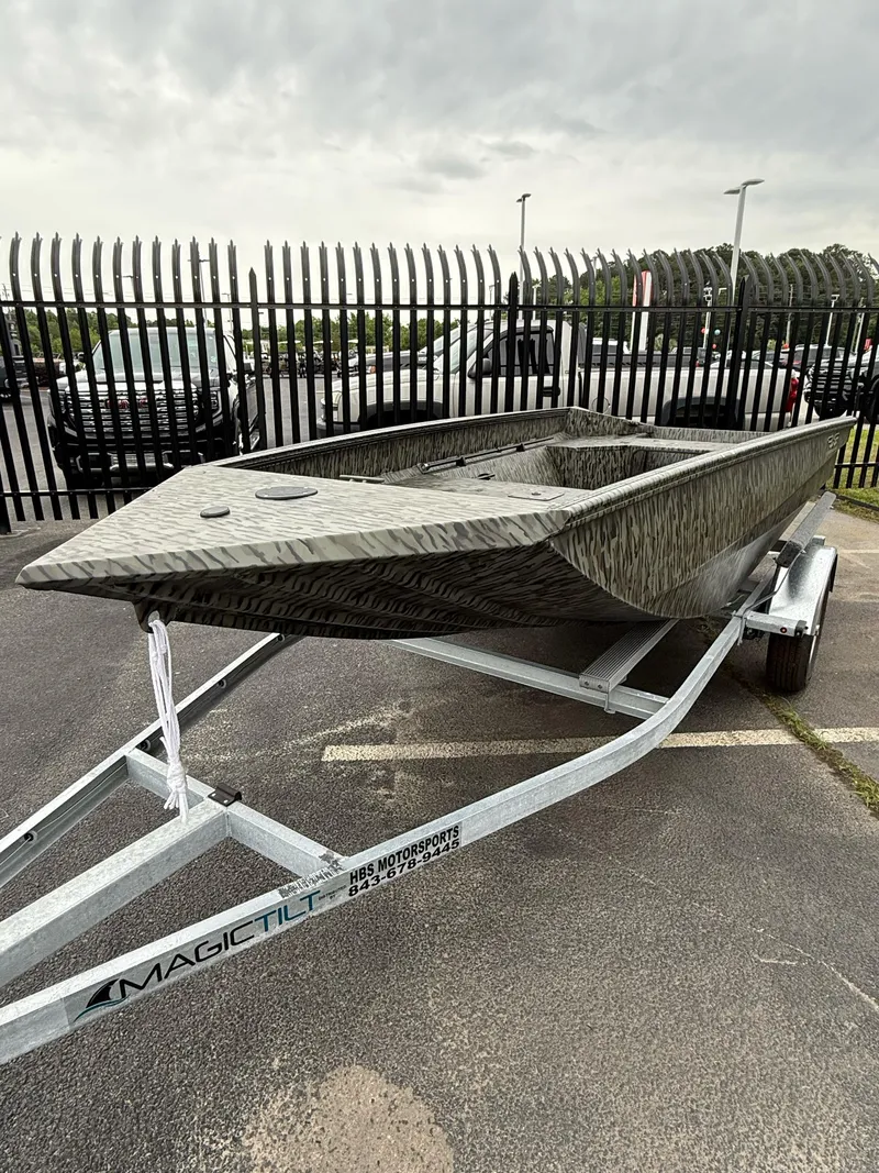 Slide: The Image of 2025 EDGE BOATS 553 Sportsman on trailer, parked outdoors, overcast sky. - 9