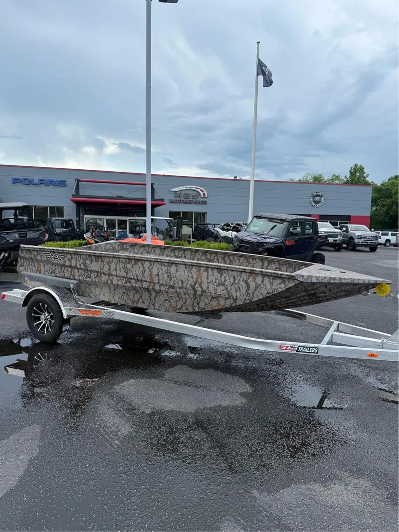 Slide: The Image of 2025 EDGE BOATS 656 SPORTSMAN on trailer, parked at dealership under cloudy sky. - 1