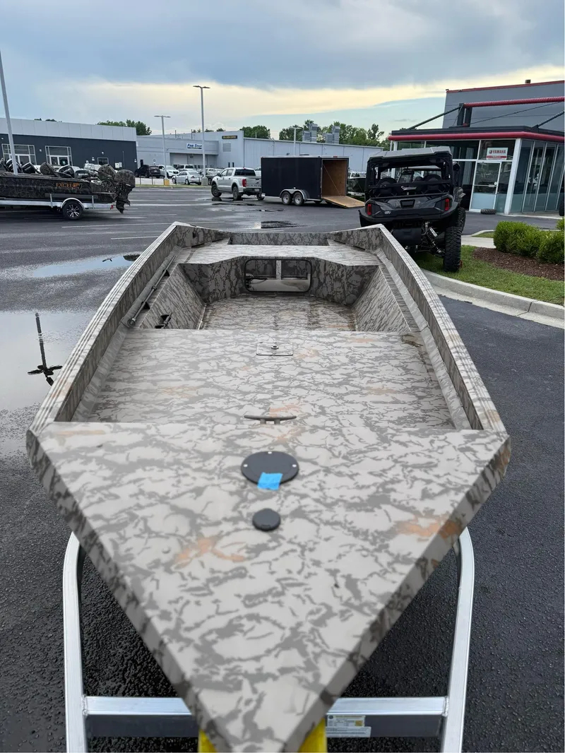 Slide: The Image of 2025 EDGE BOATS 656 SPORTSMAN with camouflage design in a dealership lot. - 3