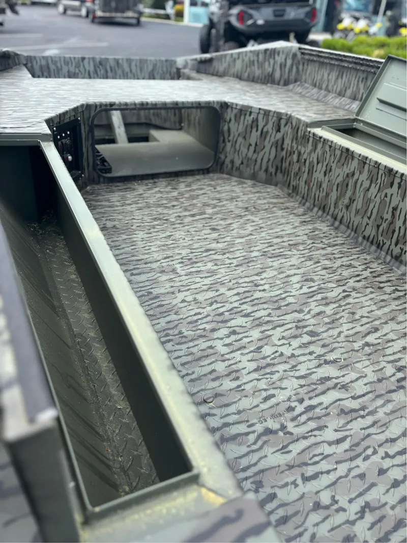 Slide: The Image of 2025 EDGE BOATS 753 interior with camouflage pattern and open storage compartments. - 11