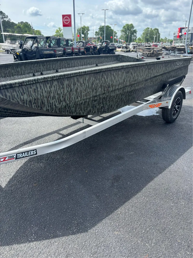 Slide: The Image of 2025 EDGE BOATS 753 on trailer, camo design, parked outdoors. - 12
