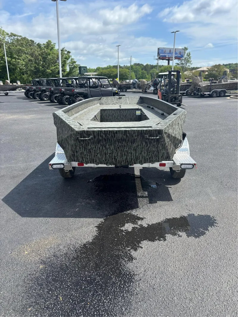 Slide: The Image of 2025 EDGE BOATS 753 on trailer, camo design, parked outdoors. - 18
