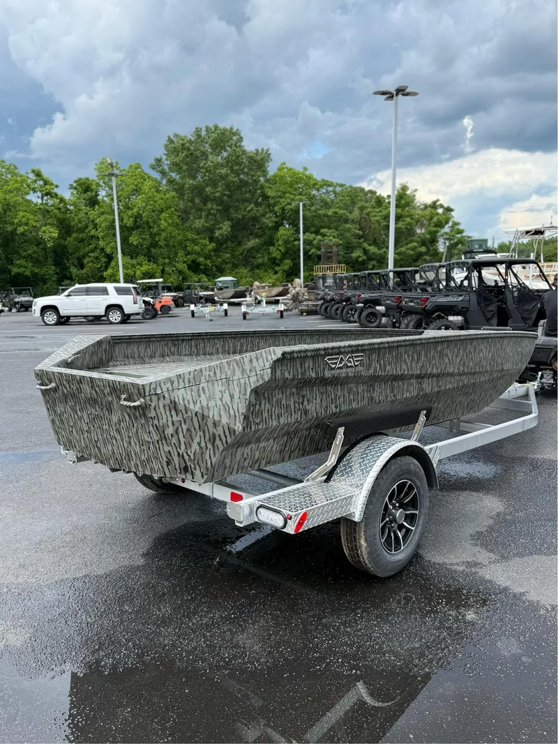 Slide: The Image of 2025 EDGE BOATS 753 on trailer, camo design, parked outdoors under cloudy sky. - 3