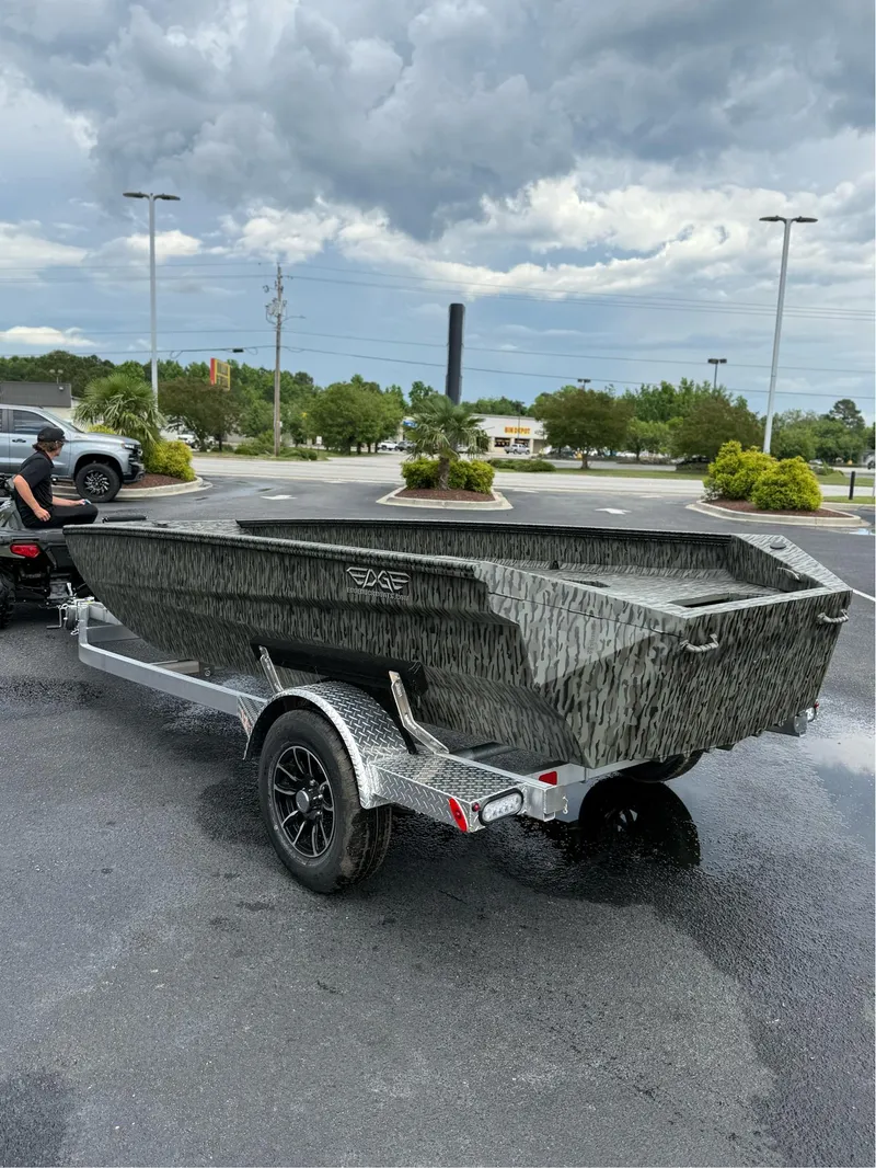 Slide: The Image of 2025 EDGE BOATS 753 on trailer, parked outdoors under cloudy sky. - 5