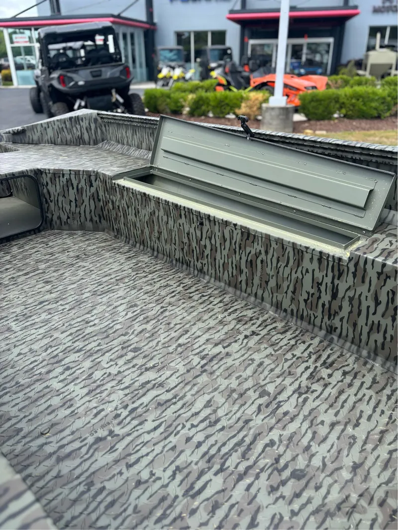 Slide: The Image of 2025 EDGE BOATS 753 interior with open storage compartment, camo pattern design. - 9
