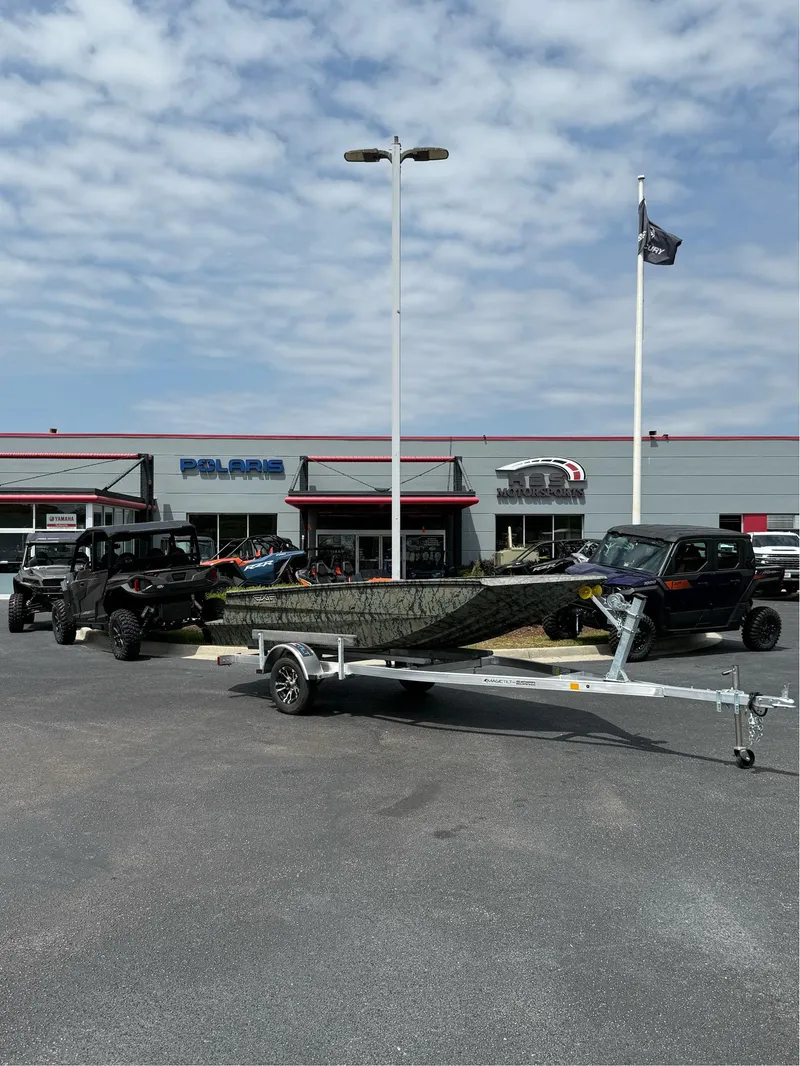 Slide: The Image of 2025 EDGE BOATS 656DB on trailer outside dealership with off-road vehicles. - 1