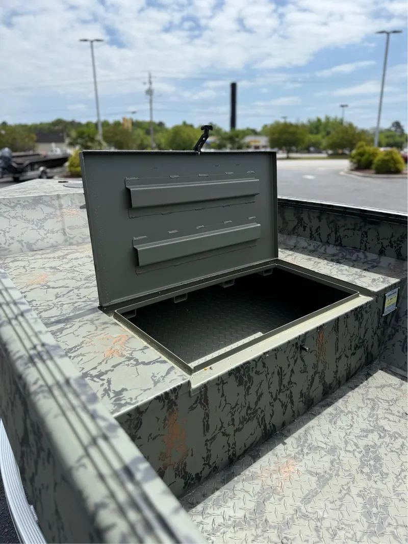 Slide: The Image of Open storage compartment on 2025 EDGE BOATS 656DB with camouflage pattern. - 2