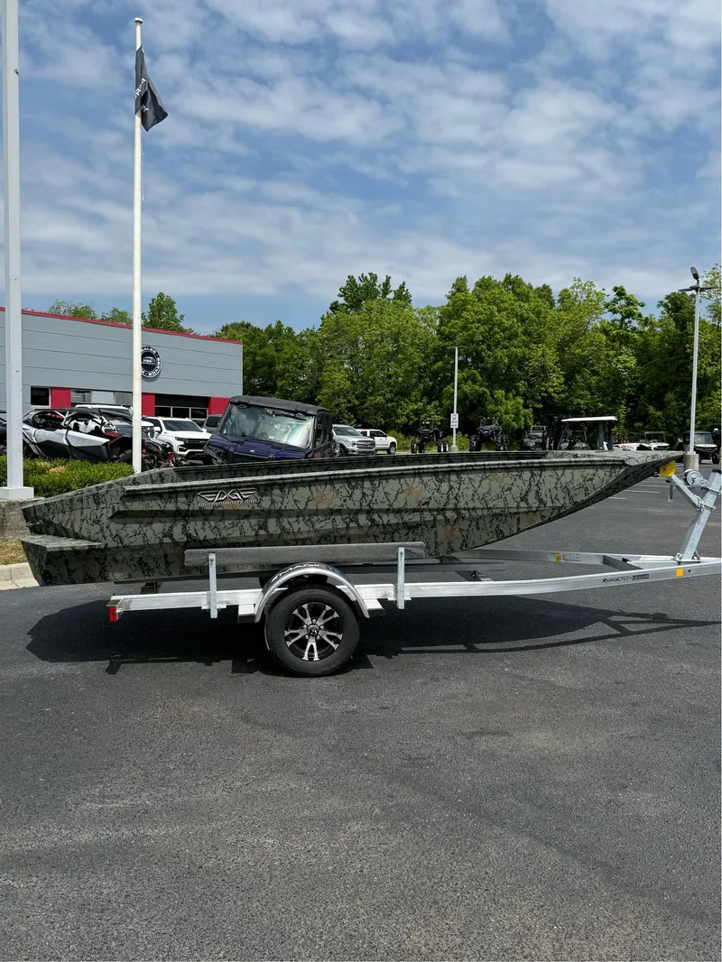 Slide: The Image of 2025 EDGE BOATS 656DB on trailer, camo design, parked outdoors near dealership. - 5