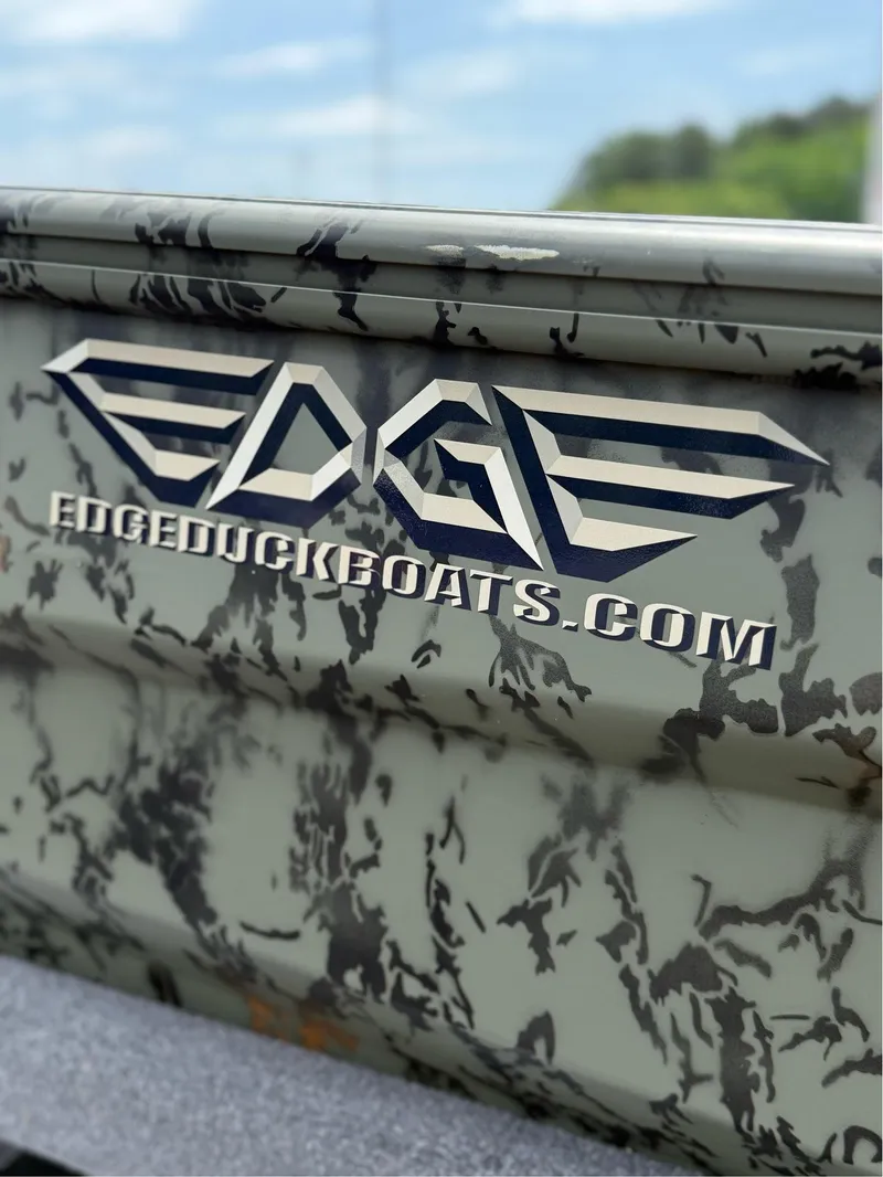 Slide: The Image of Camouflage-patterned EDGE BOATS 656DB, 2025 model, with logo and website URL. - 6