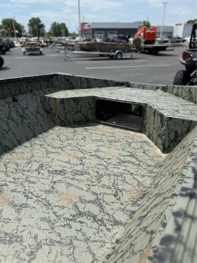 Slide: The Image of 2025 EDGE BOATS 656DB interior with camouflage pattern, parked outdoors. - 7